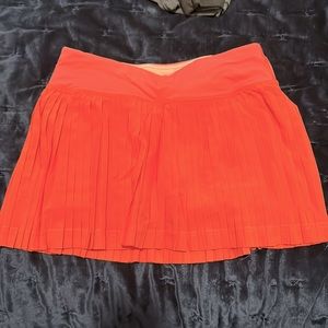 Lululemon run pace skirt pleated coral color size 2 fabric inner tag attached
